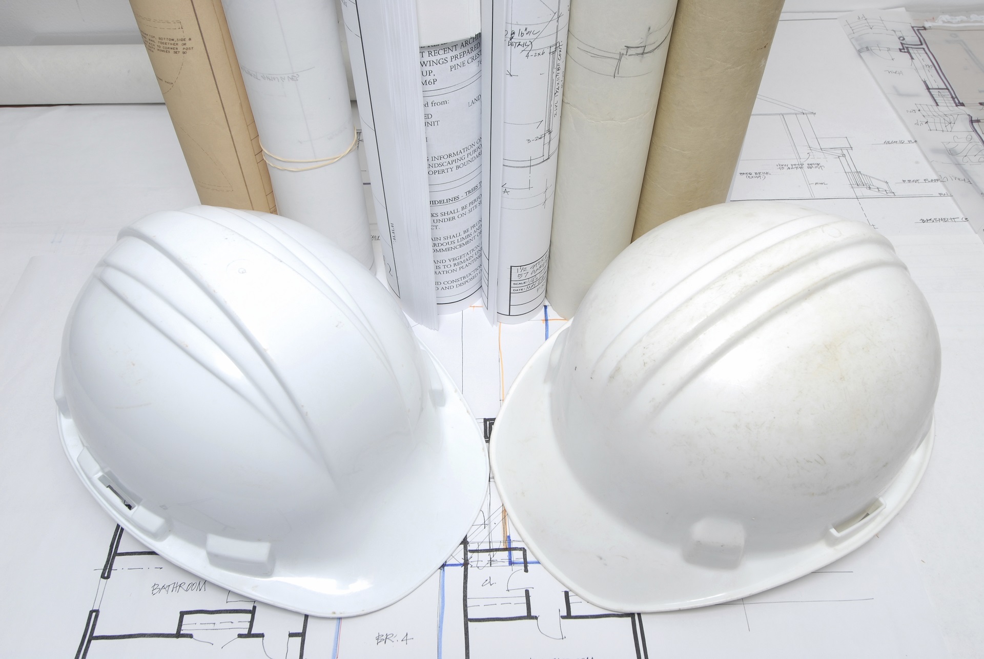 Construction plans, safety gear, and hard hats